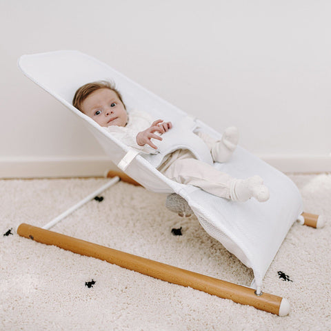 baby sat in a white Evolux baby bouncer