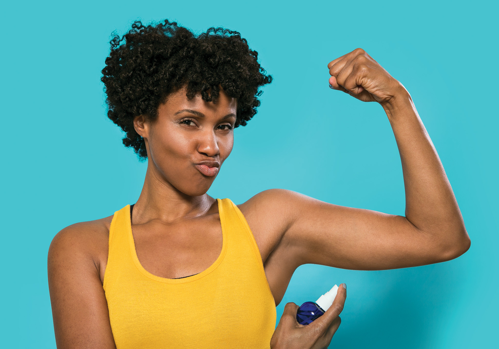 woman using a natural spray deodorant