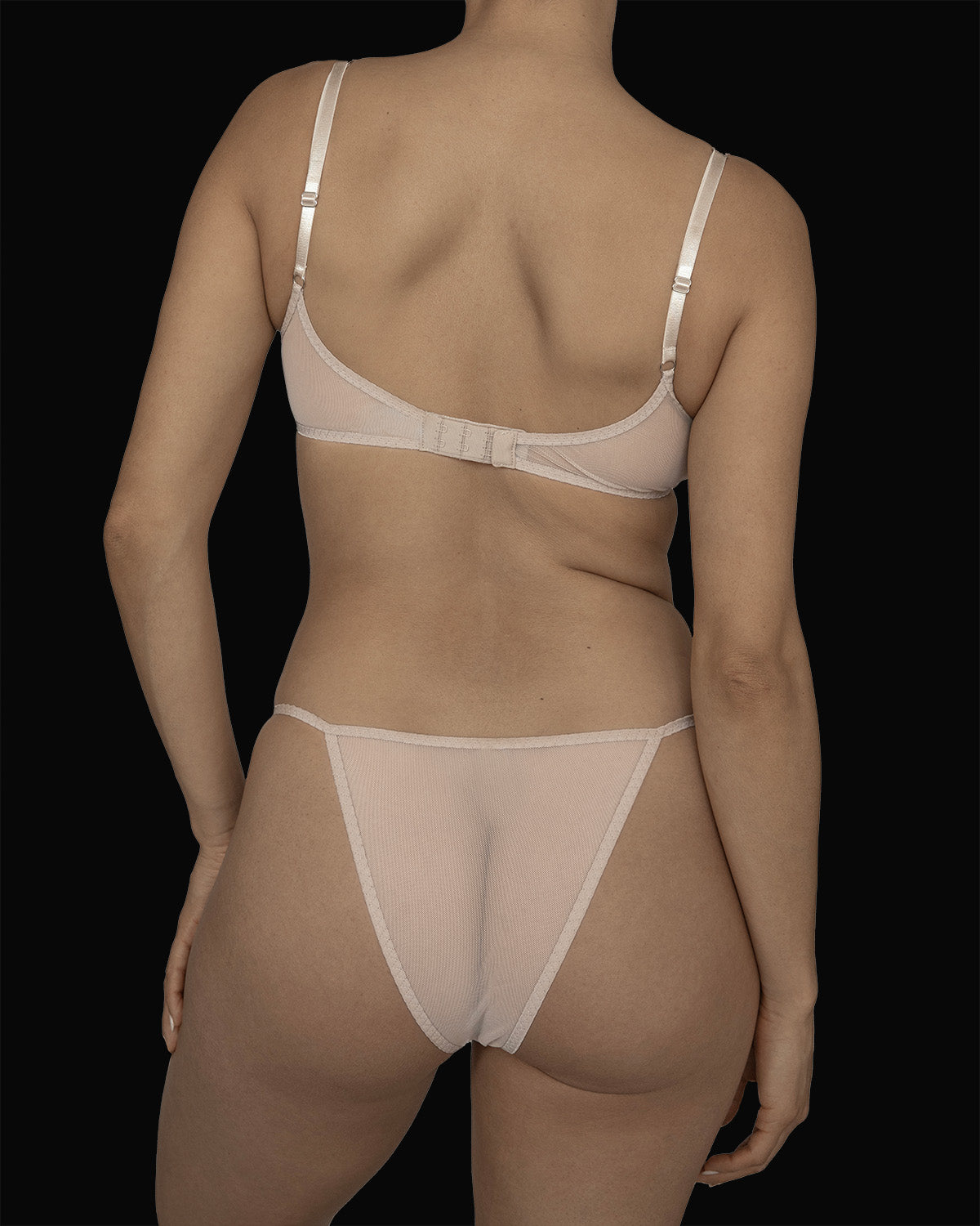 The Kye Intimates Ikebana Bra in the color ecru. A deep scoop neck bra with wide adjustable shoulder straps and an adjustable back clasp. This sheer bra is both dainty and sensual.