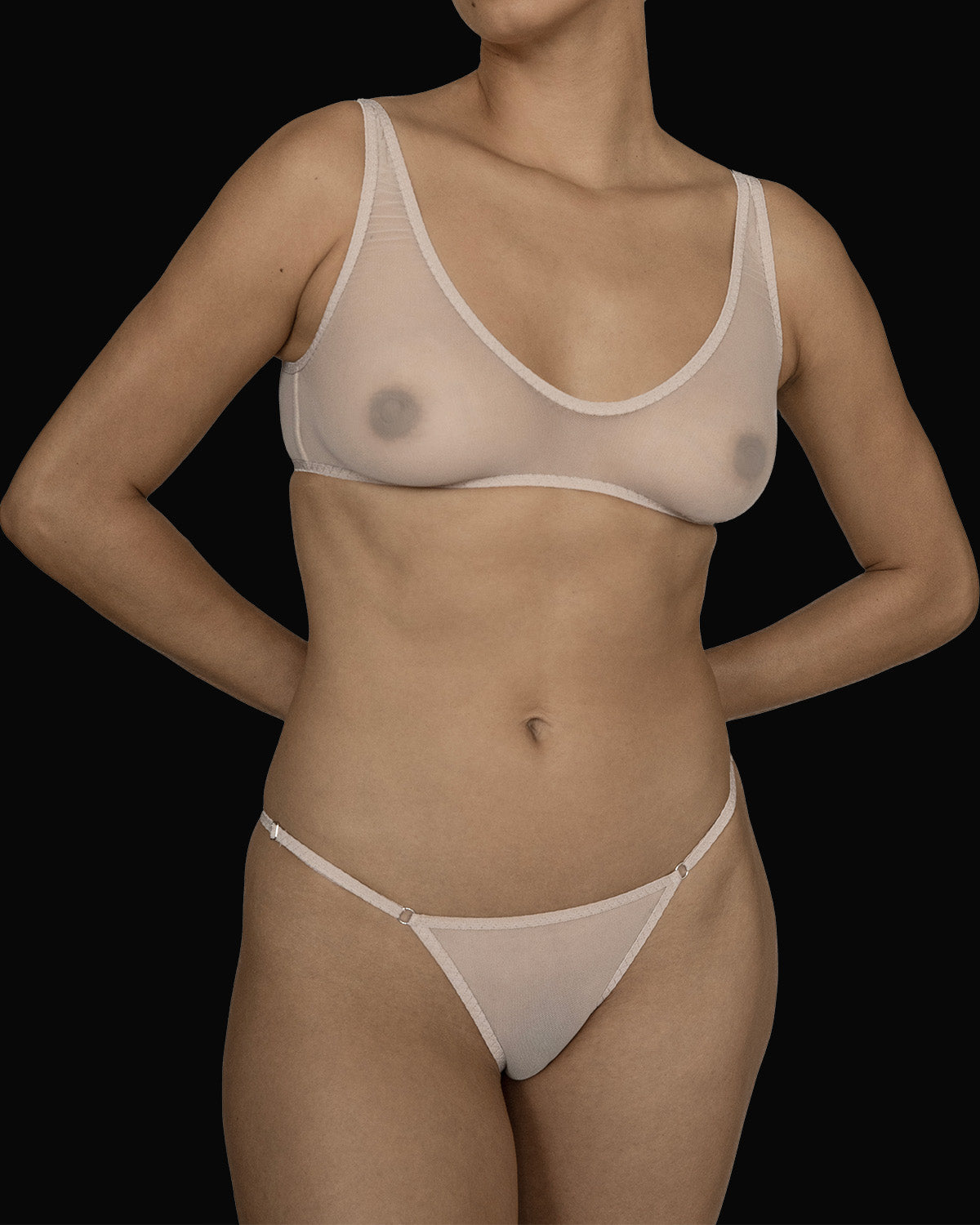 The Kye Intimates Ikebana Bra in the color ecru. A deep scoop neck bra with wide adjustable shoulder straps and an adjustable back clasp. This sheer bra is both dainty and sensual.