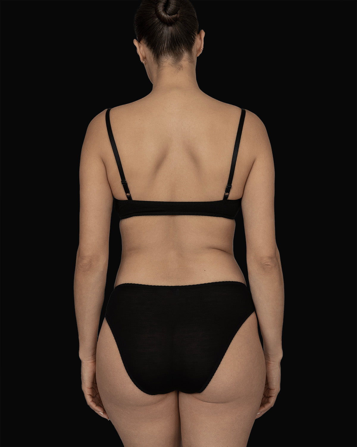 The Kye Intimates Recline Brief in the color Black. mid rise underwear that provides moderate coverage. Made from soft, environmentally conscious bamboo that is naturally moisture wicking and bacteria resistant. These breathable briefs have temperature regulation properties making them a comfortable choice to wear to bed.