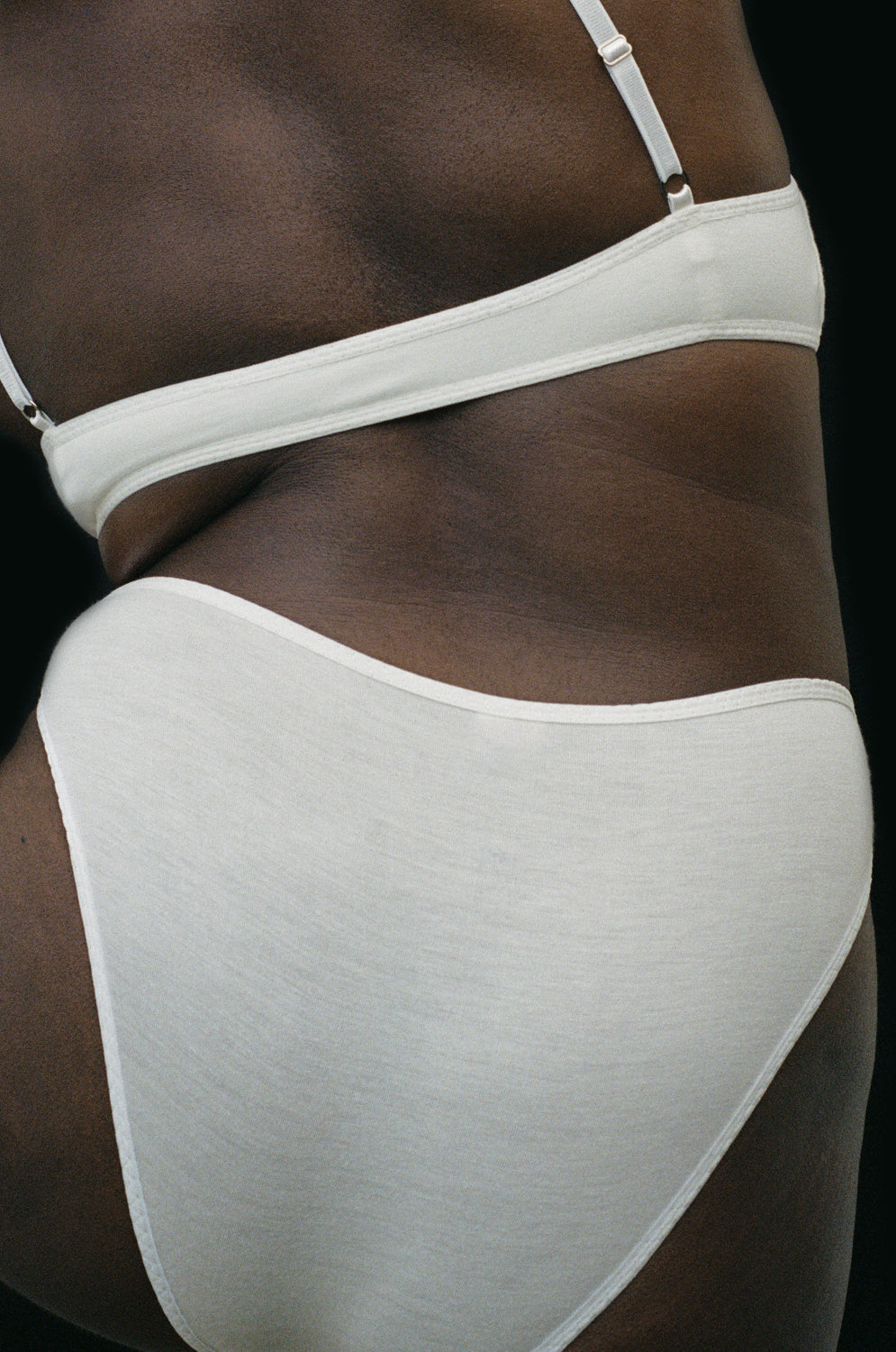 A view of the back of the Kye Intimates Recline Brief in the color Natural. mid rise underwear that provide moderate coverage. Made from soft, environmentally conscious bamboo that is naturally moisture wicking and bacteria resistant. These breathable panties have temperature regulation properties making them a comfortable choice to wear to bed.