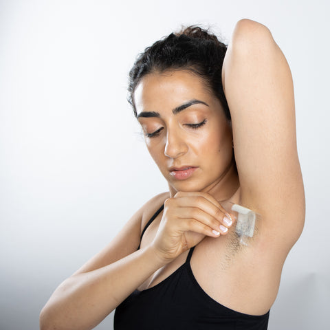 Woman waxing her underarm with Parissa Wax Strips 