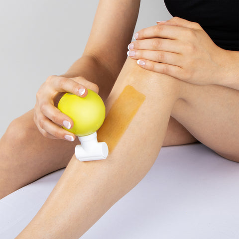 woman waxing her leg with Parissa Sugar Wax Roll on