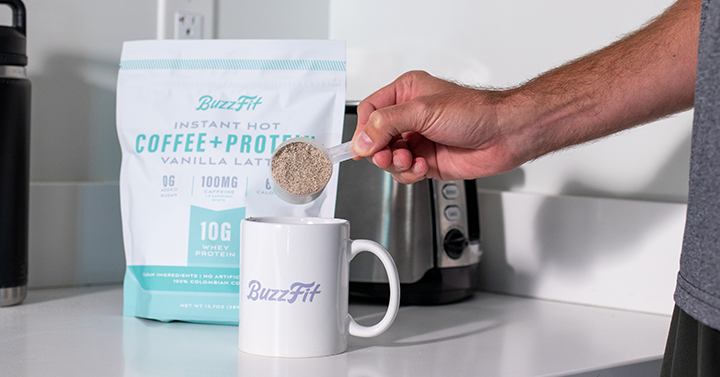 Hand Pouring BuzzFit into a Mug