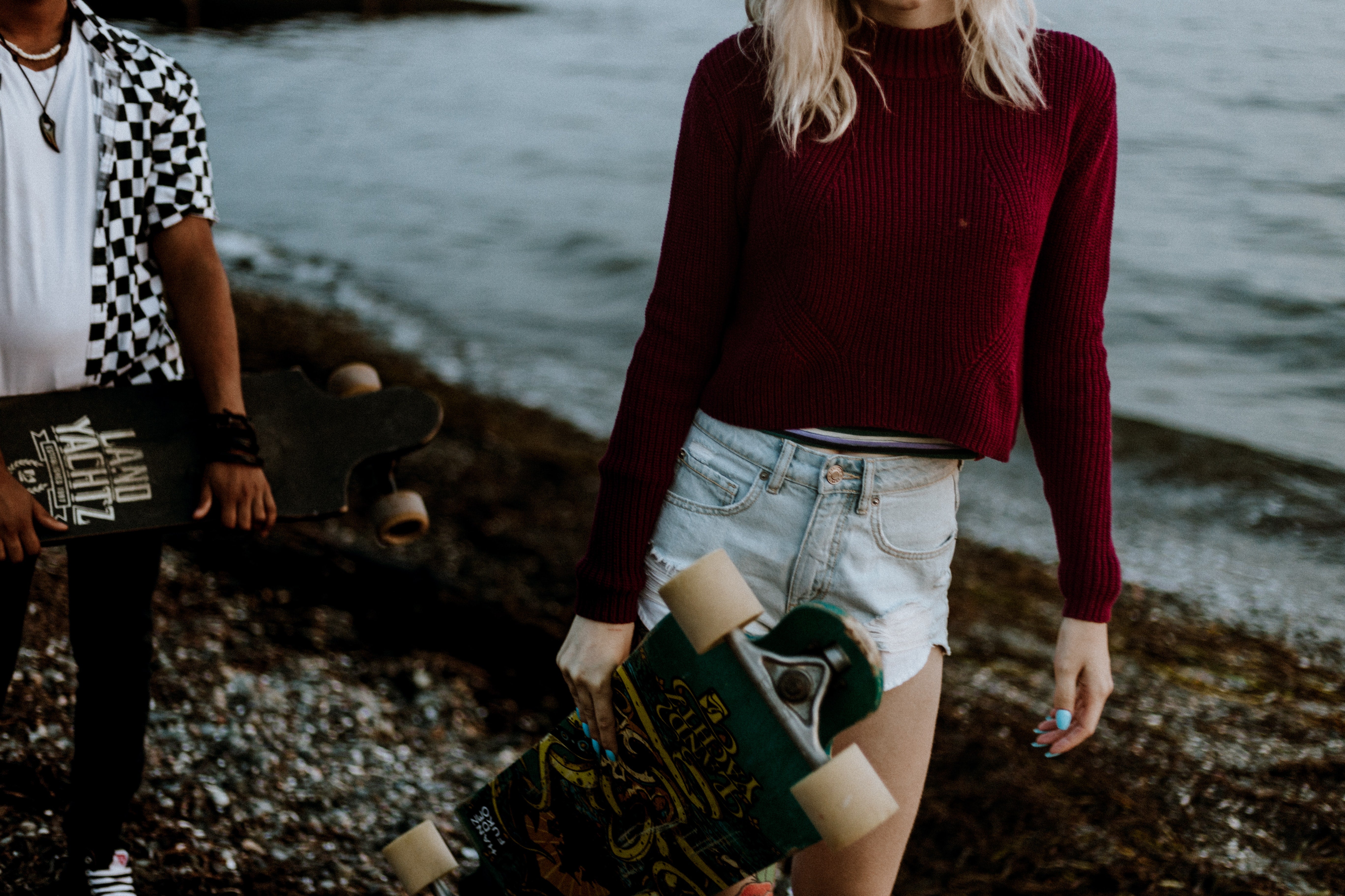 Two People Holding Longboards