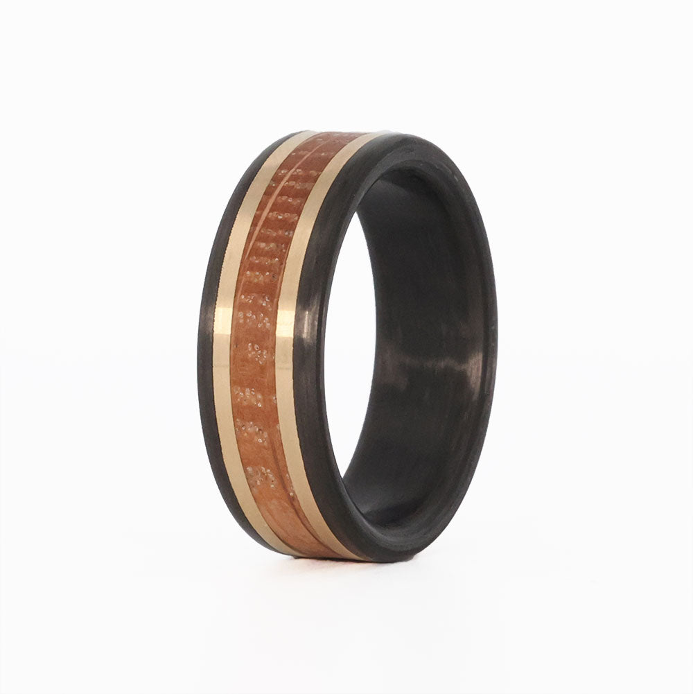 Carbon Fiber, whiskey barrel, and gold wedding ring