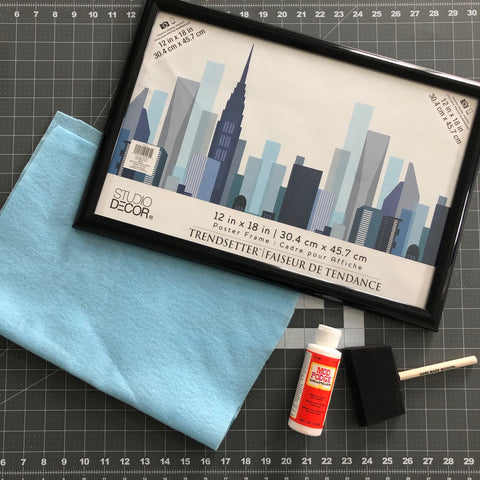 Supplies to make your own picture frame felt board that hangs on a wall.