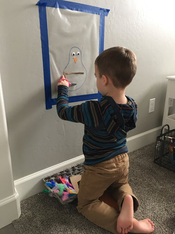 Toddlers and preschoolers need vertical wall activities.  Make this contact paper turkey craft as a screen free activity to keep them busy and work on fine motor skills.  Plus it's a cute Thanksgiving decoration!