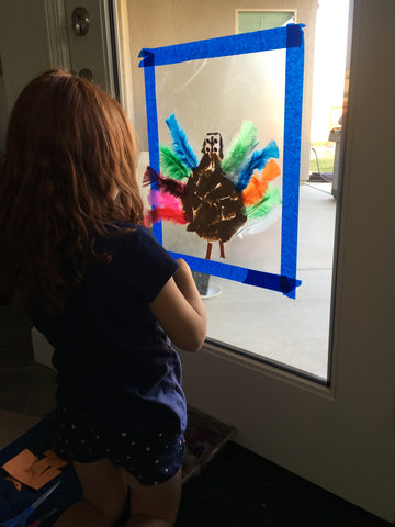 Toddlers and preschoolers need vertical wall activities.  Make this contact paper turkey craft as a screen free activity to keep them busy and work on fine motor skills.  Plus it's a cute Thanksgiving decoration!