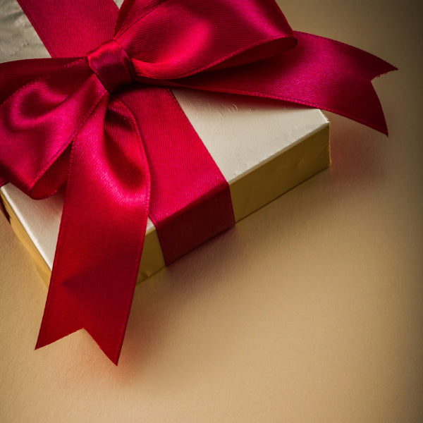 December birthday gift ideas - red bow gift - Birthday Butler