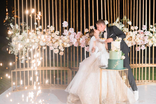 side-view-happy-bride-groom-which-eating-wedding-cake-kissing-each-other-while-standing-background-beautiful-wedding-arch-which-decorated-by-metal-roses-evening-ceremony_8353-12641.jpg__PID:21df3274-ceeb-46ac-b04e-ea6755bbf5d5