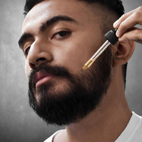 man applying beard oil