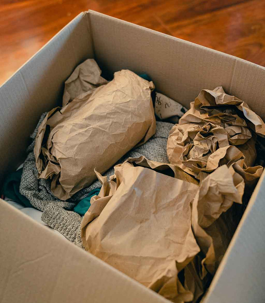 filling the box with towels and packing paper