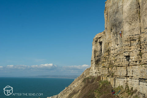 Pongoose Blog - Blacknor Central climbing area, Portland. Climber on cliff with blue sea behind. 