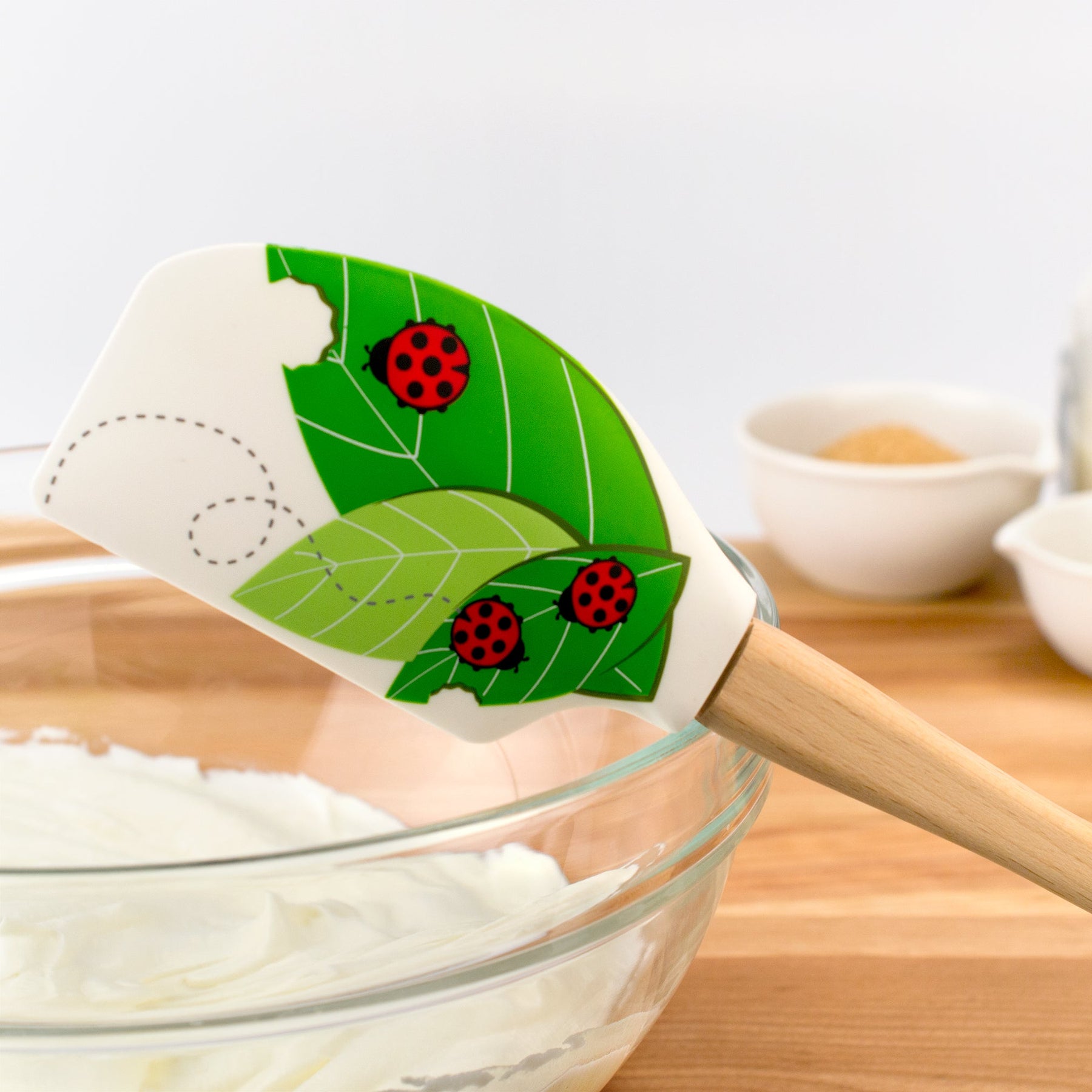 https://cdn.shopify.com/s/files/1/2178/5793/products/tovolo-spatulart-wood-handled-ladybug-leaves-spatula-656267_1800x1800.jpg?v=1698416123