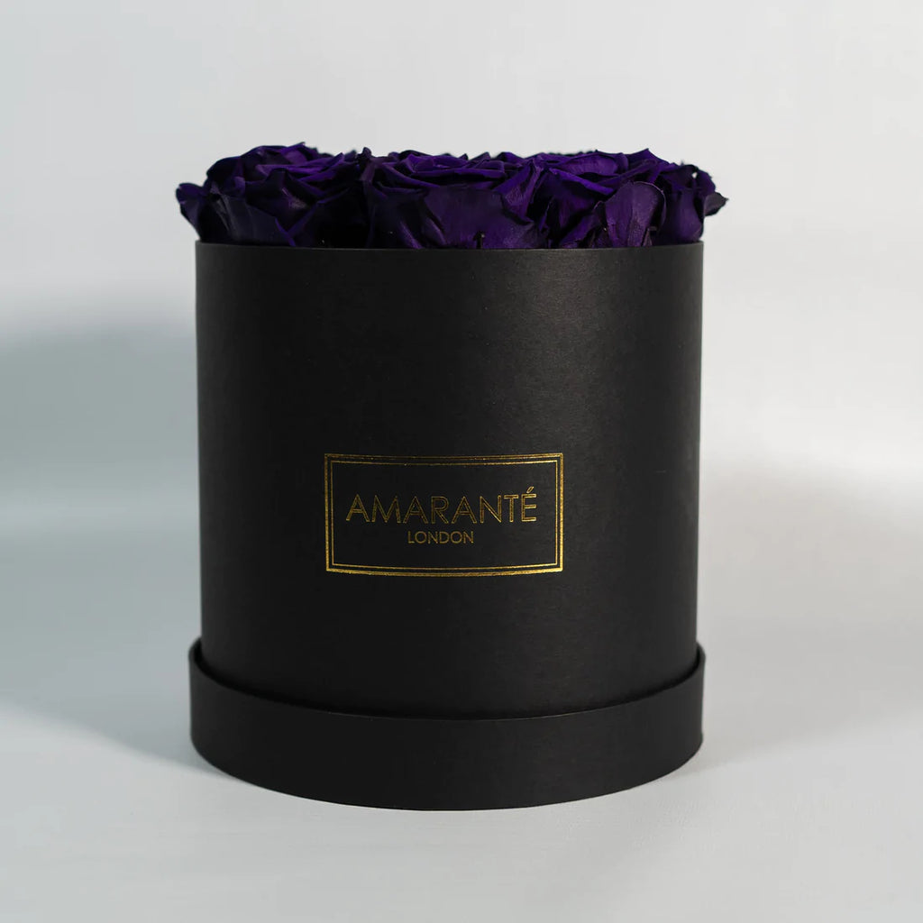 13 Purple roses in a black round rose box with a matte finish