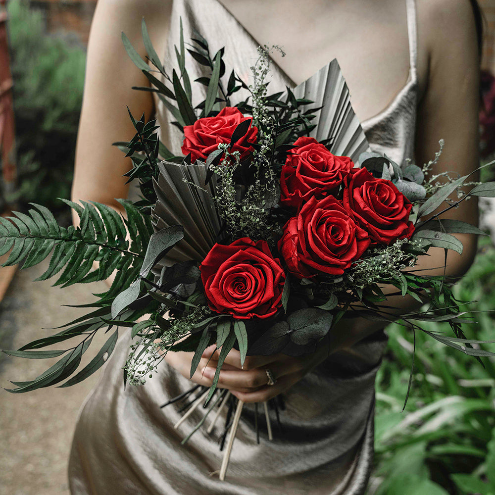 Elegant bridesmaid bouquet to match any wedding theme, features 5 large red roses along with Eucalyptus cinera, Eucalyptus nicoli green, Ruscus green, Lepidium, Sword fern and Mini spear.