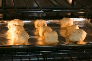 Place all 8 on a baking sheet, seam side down. Use a fork or knife to poke four holes in the top, allowing the bites to vent. Place in middle rack of the oven and bake for 12 minutes. 