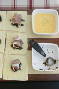 On each pastry square, place 1 tsp of the mushroom mixture in the center. Wrap each filet bite with prosciutto, then place it on top of the mushroom mixture. 