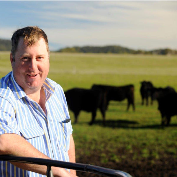 A cattle rancher in front of his cattle