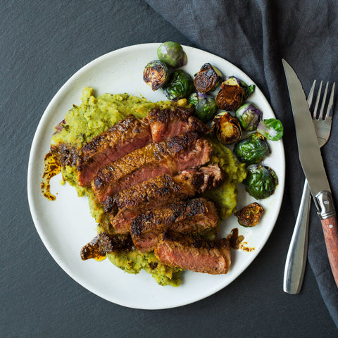Turmeric rubbed steak on top of kale mashed potatoes and brussel sprouts.