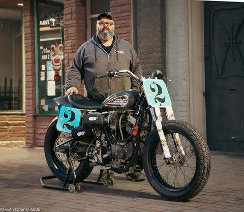 Guy Morden standing with his Harley-Davidson XR750