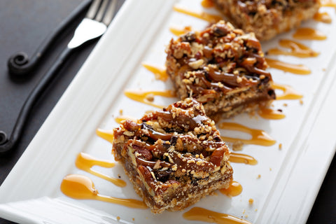 pecan pie bars on a white plate