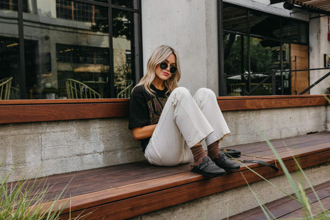 Model wearing Abel Black Glitter Clogs