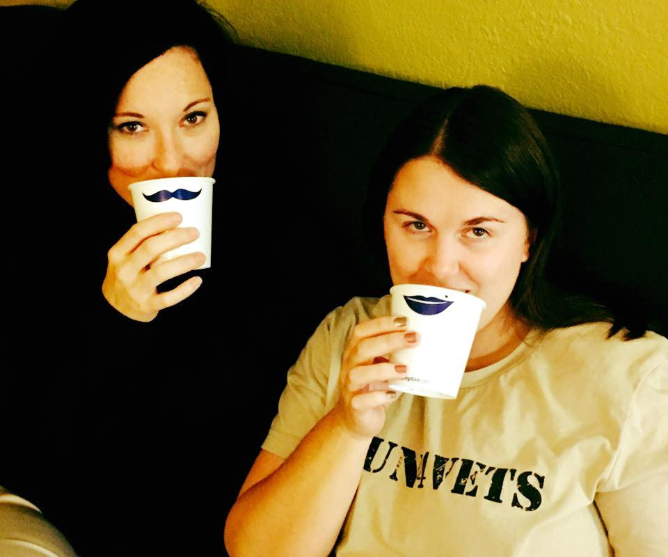 Woman drinking out of mustache cup