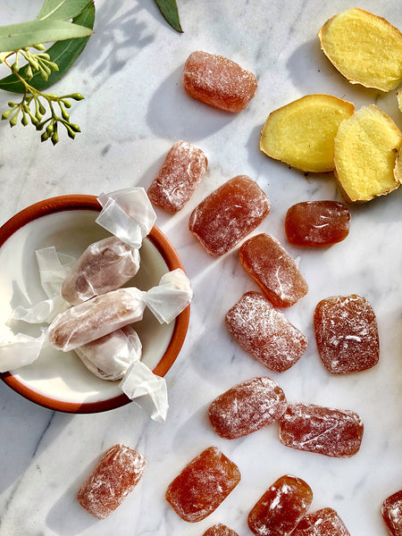 Urban Moonshine Bitter Ginger Chews laid out on marble with ginger