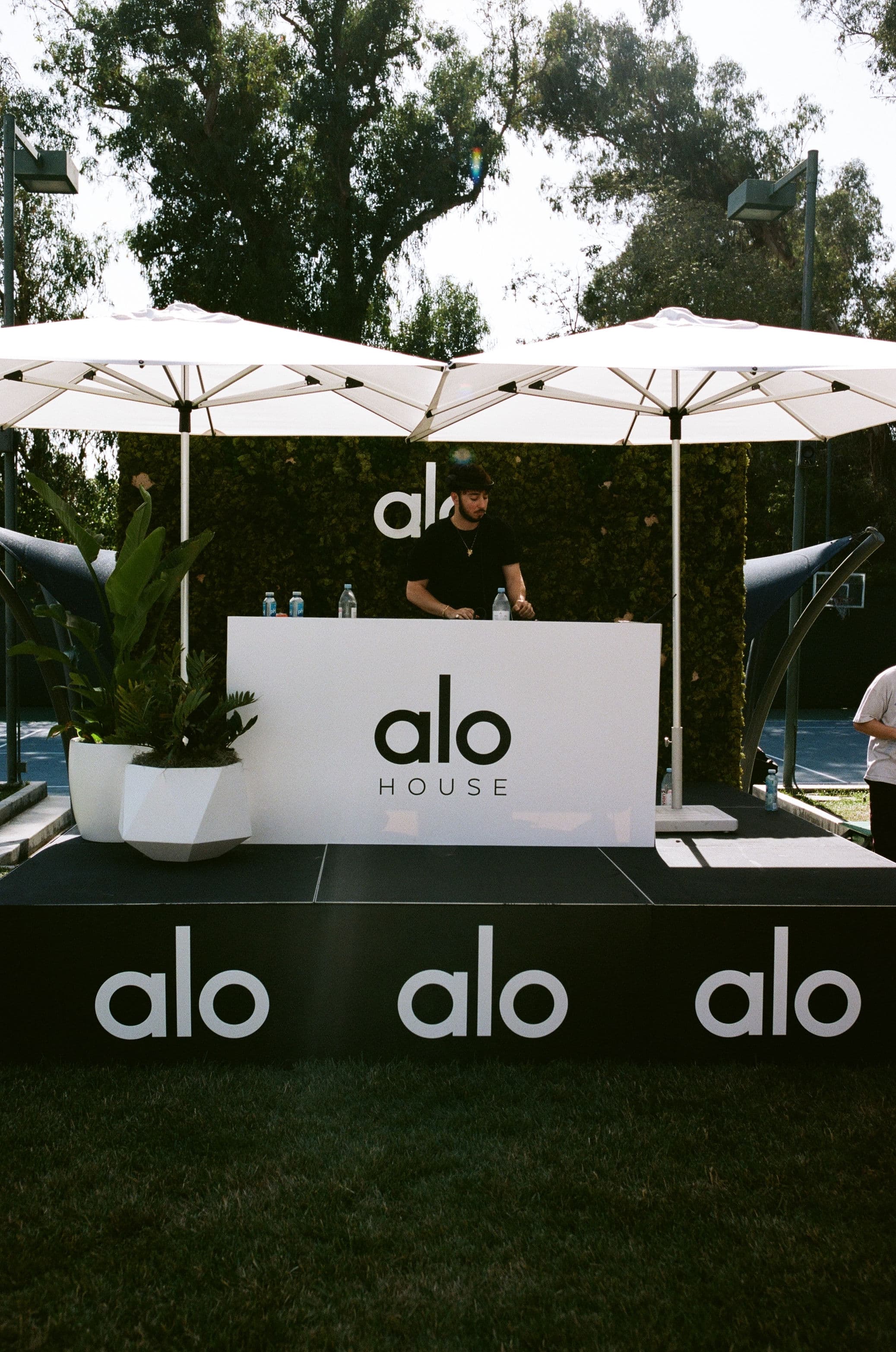A photo of the DJ booth at Alo Summer House 2022 with Zack Bia behind the booth. 