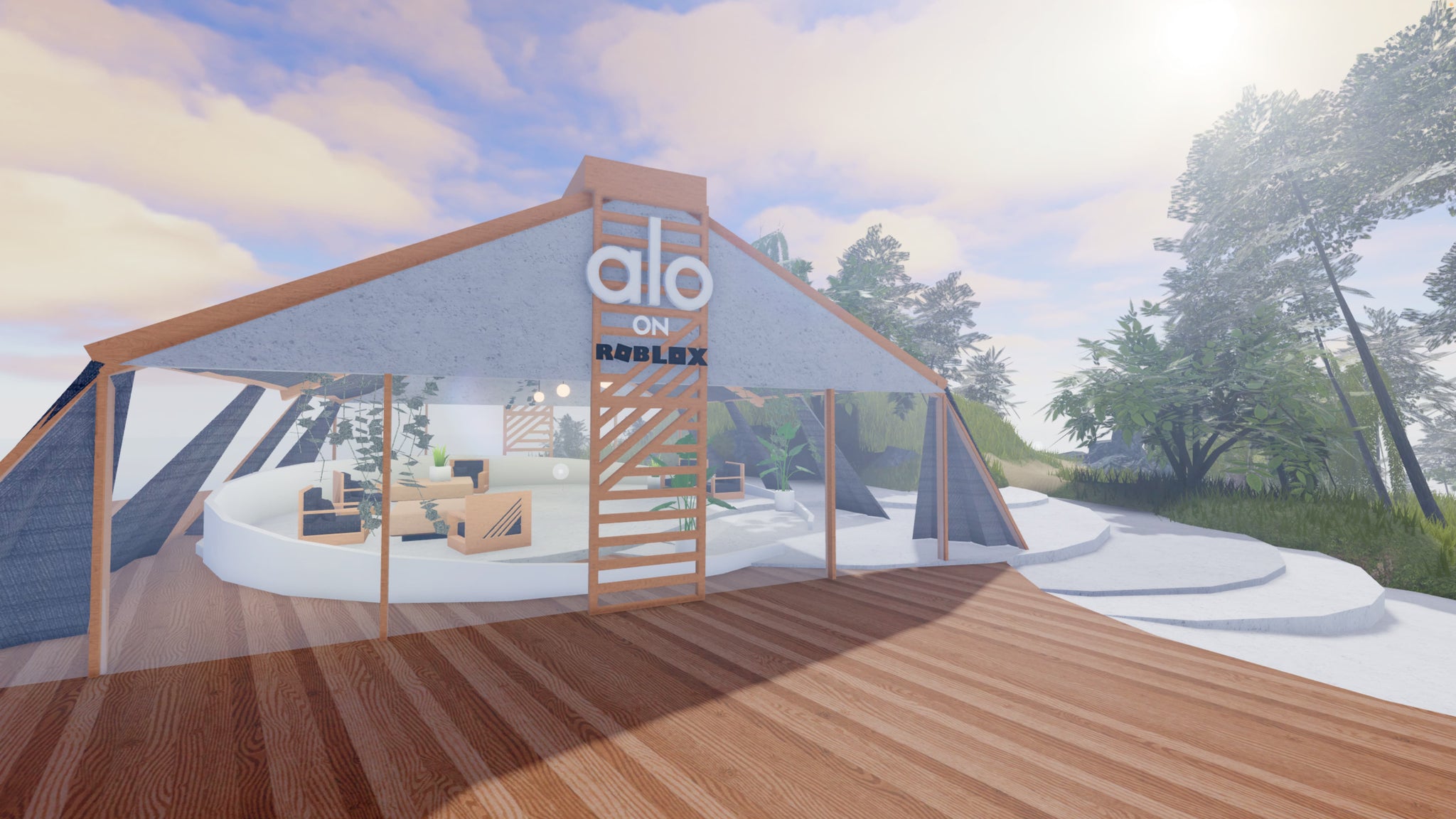 A photo of the virtual, open-air Alo Sanctuary meditation tent made from natural wood beams and placed upon a mountain ridge overlooking the ocean.  