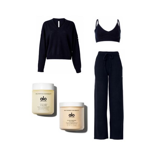 An image of product flatlays including a black long sleeve cashmere pullover, a cashmere bra top, a pair of black wide-leg cashmere pants, and Alo’s Renew & Glow Body Polish with the Mindful Magnesium Bath Soak.  