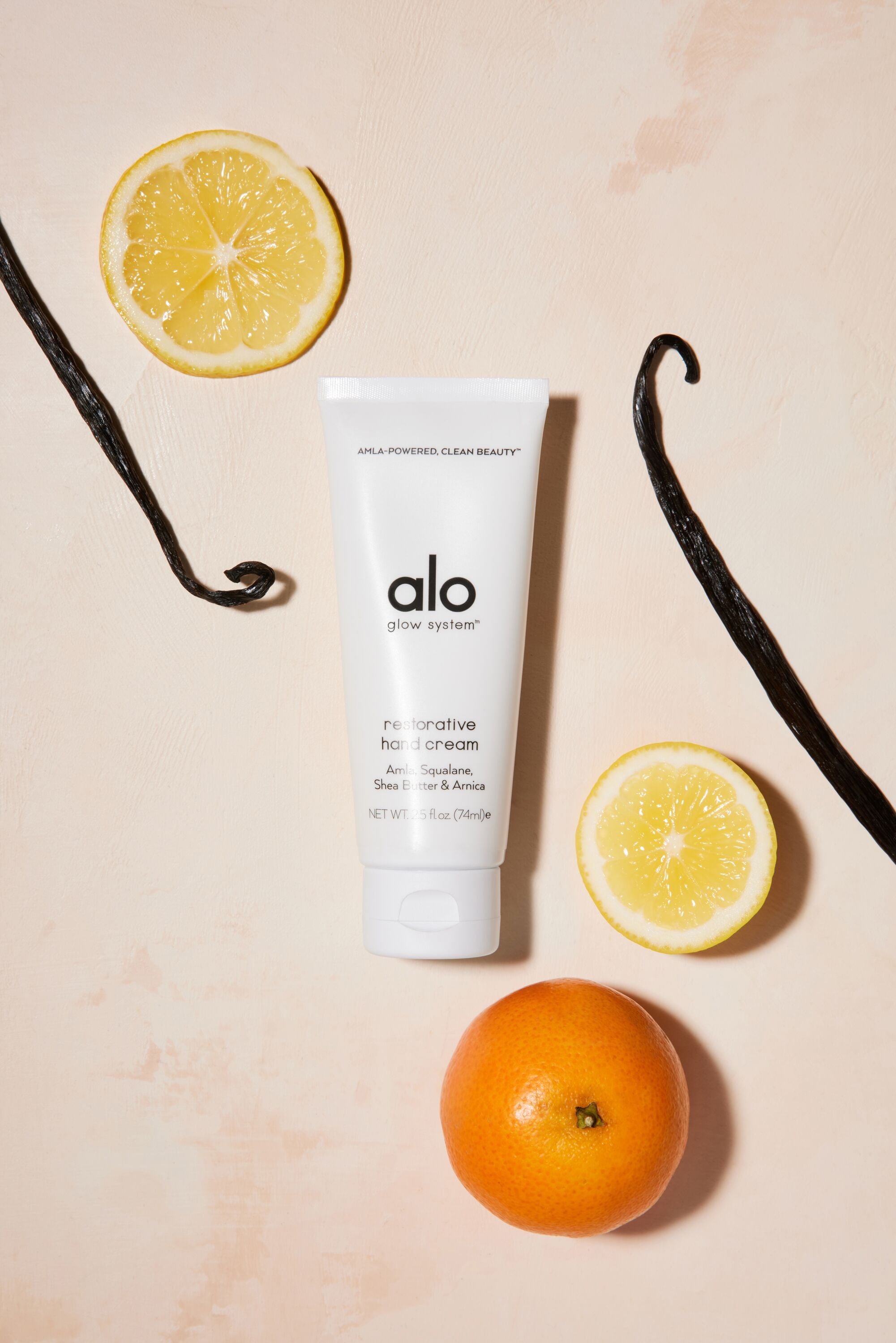 Restorative hand cream flat lay with oranges and shea butter