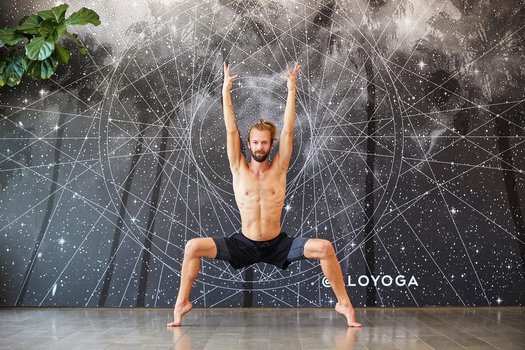 @invertedyogi in Goddess Squat while in the Alo Yoga studio teaching a class.  