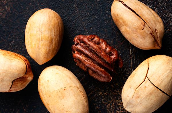Best nuts for weight loss Pecans on dark background