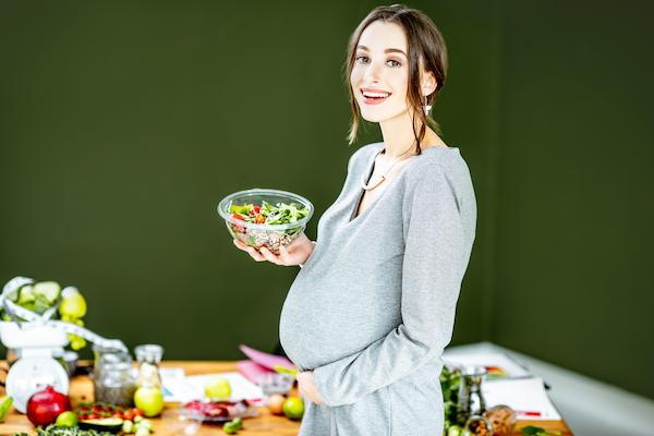 Pregnant lady with Plant-based foods for fertility