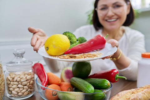 A lady holding a plate of flexitarian diet foods.