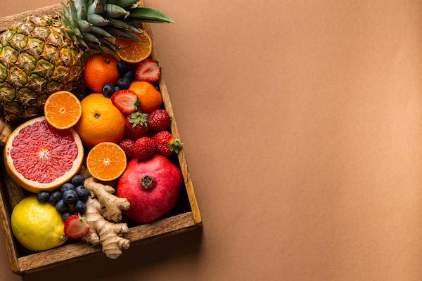 Wooden box of fruit containing Vitamin C