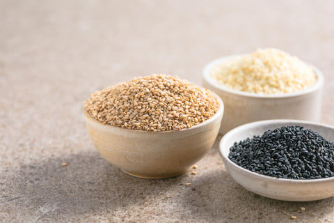 Black and White sesame seeds in different bowls.