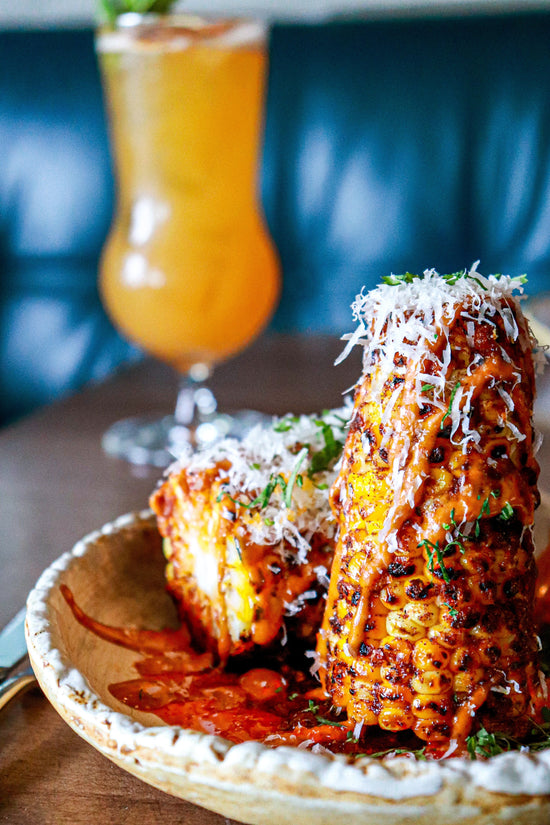 Maxican street corn, elote, or esquites with a Margarita