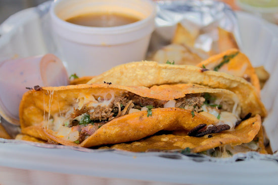 A Vegan Birria Taco on a platter with sauce