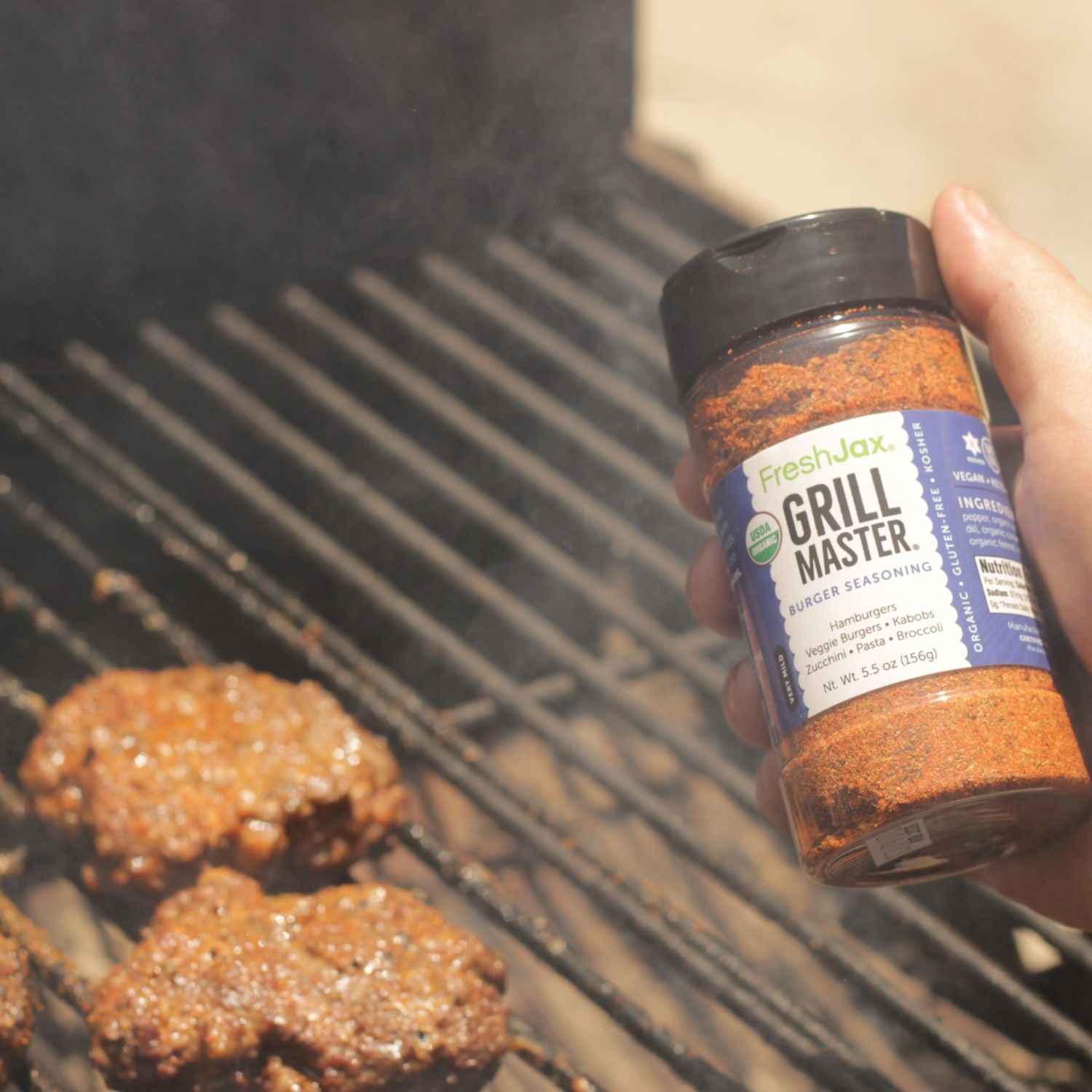 https://cdn.shopify.com/s/files/1/2186/8311/t/68/assets/freshjax-organic-spices-grill-master-burger-seasoning-with-burgers-on-the-grill-1678362970822.jpg?v=1678362971