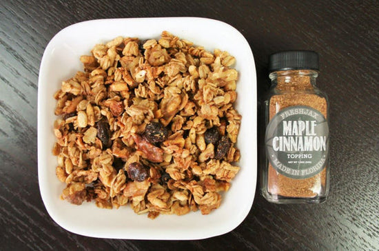 A Bowl of Maple Cinnamon Granola with a sampler bottle of FreshJax Maple Cinnamon Topping