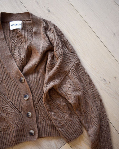 A camel coloured button up cardigan