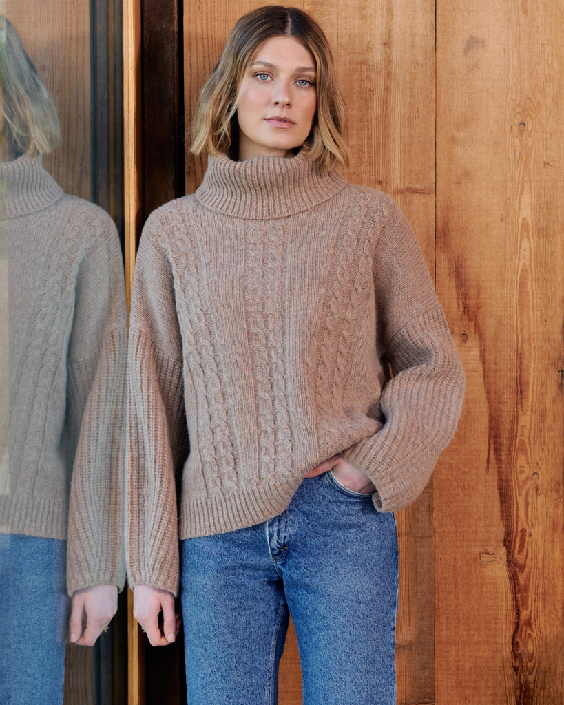 A model wearing a chunky wool knit jumper