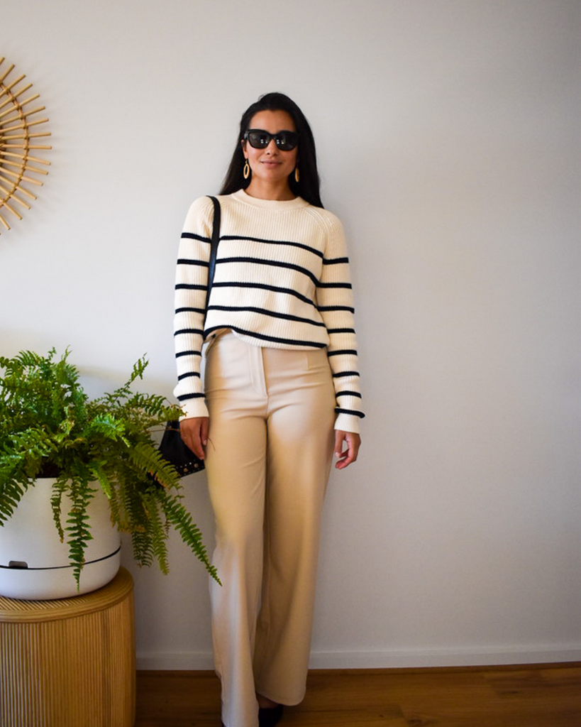 a model wears a breton stripe pullover