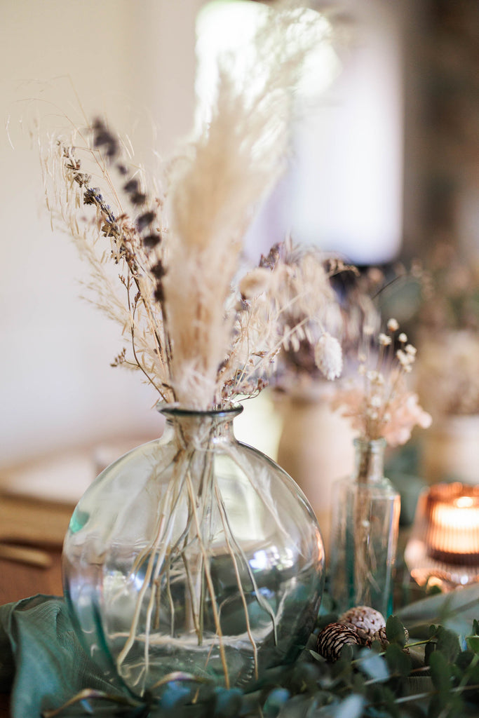dried flowers in recycled glass vase