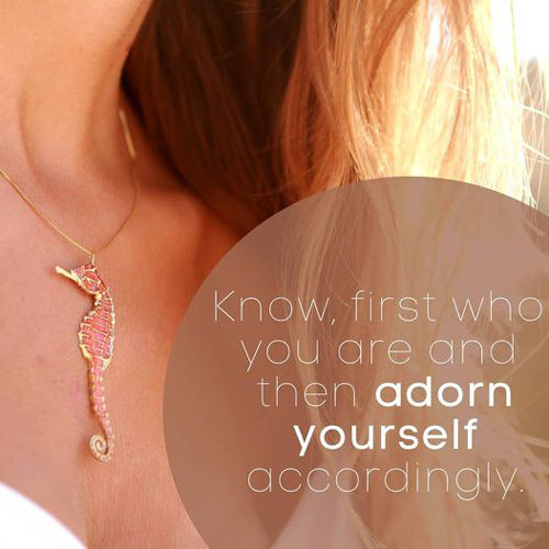 woman wearing rose-quartz sterling silver seahorse necklace with a caption reading “know first who you are, and then adorn yourself accordingly”